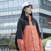 Simmerui woman wearing a stylish orange and black outdoor jacket, blending functionality and street fashion for everyday wear
