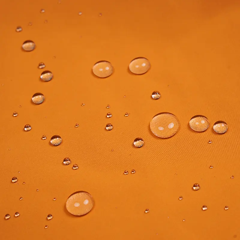 Close-up of water droplets on the fabric of Simmerui men's waterproof jacket, showcasing water-resistant material