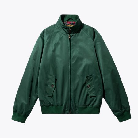 Close-up view of a green bomber jacket with a red plaid interior, showing the inside design and details.