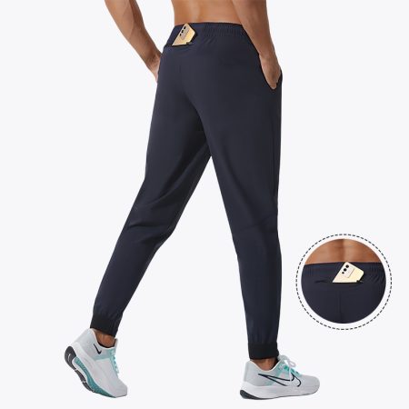 Men's navy-blue jogger pants with elastic waistband and zippered pocket, showcasing a phone in the pocket.