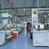 Factory floor showing workers assembling garments in an ethical apparel manufacturing setup.