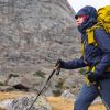 Hiker wearing technical outerwear and carrying a large backpack during a mountain trekking test