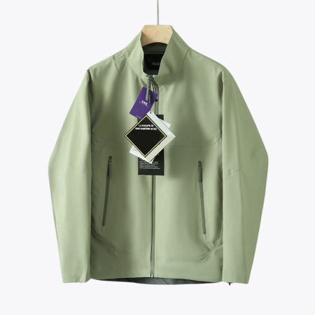 Front view of lightweight hardshell outdoor jacket with zip pockets in misty-green