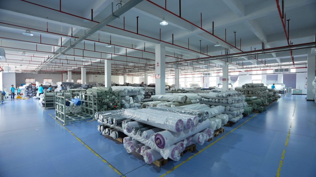 Factory view with rolls of textiles ready for bulk production and dyeing.
