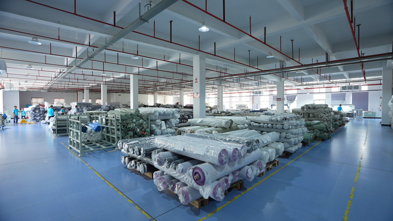 Factory view with rolls of textiles ready for bulk production and dyeing.