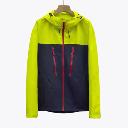 patchwork-green technical hard shell jacket with full front zipper and hood on hanger.