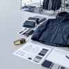 Apparel manufacturing cost planning with technical jacket samples, fabric swatches, and production materials
