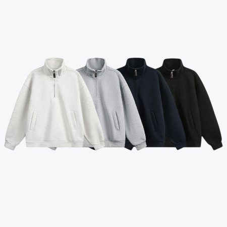 Four color options for the quarter-zip pullover sweatshirt: white, grey, navy, and black oversized drop-shoulder tops displayed side by side.